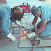 Cutting welding metal rods by National Institute for Occupational Safety and Health. Two workers cutting and welding metal rods. Workers can be seen wearing gloves and eye protection.