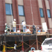 Painters using safety equipment, by National Institute for Occupational Safety and Health. These workers are preparing for a paint job using proper harness safety.