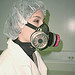 Worker wearing half-mask replaceable particulate filter respirator, by National Institute for Occupational Safety and Health. Side view of half-mask replaceable particulate filter respirator.