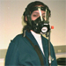 Worker wearing positive-pressure supplied air respirator, by National Institute for Occupational Safety and Health. Side view of positive-pressure supplied air respirator.